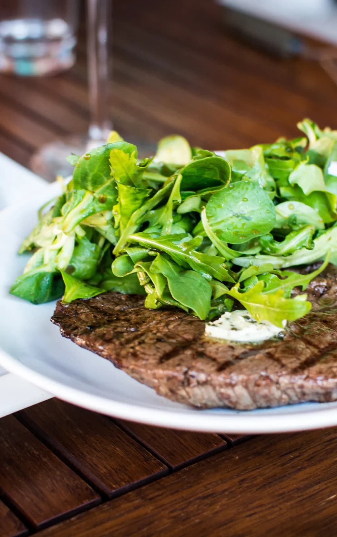 A grilled steak platter with greens