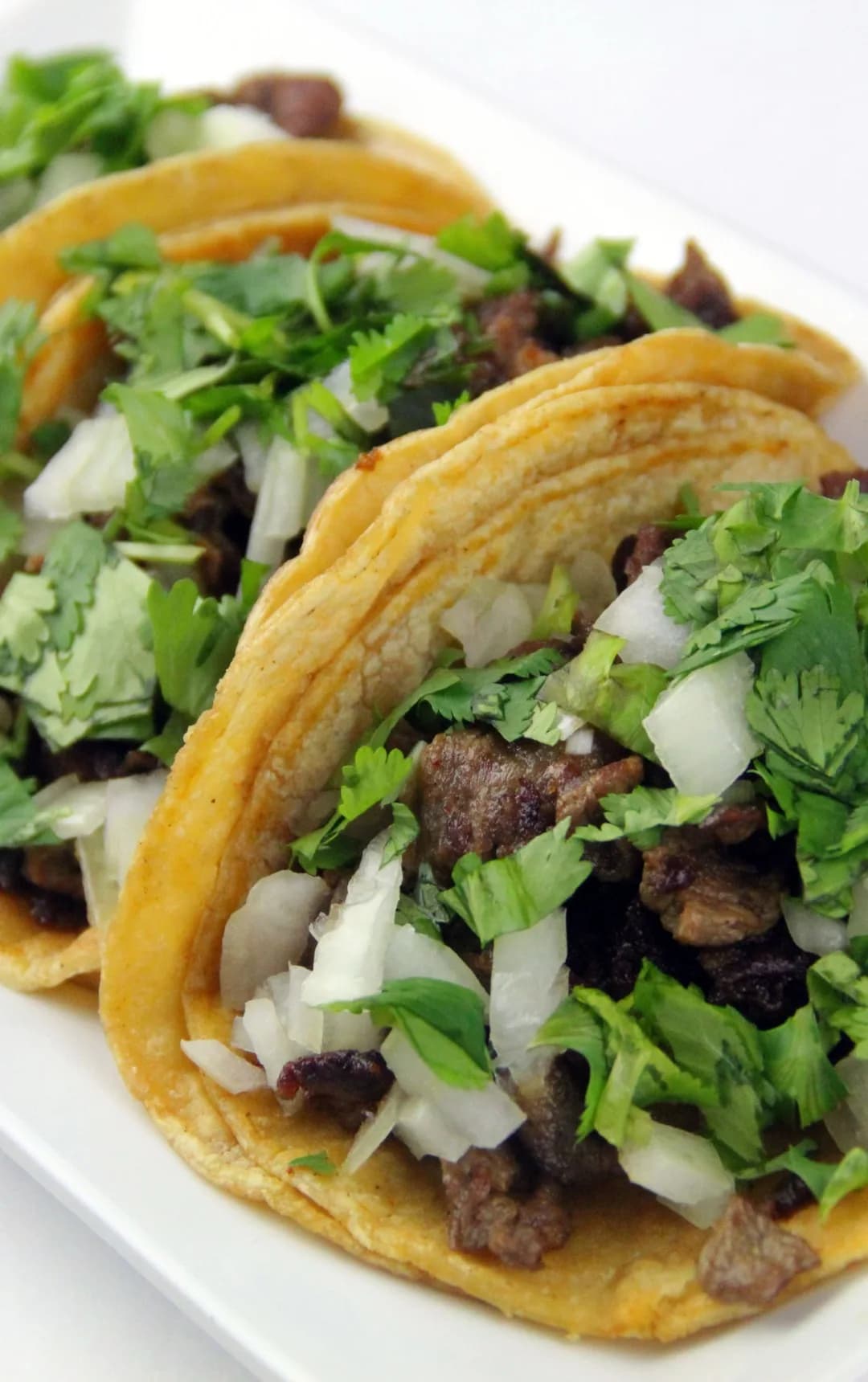Tacos topped with salsa and coriander