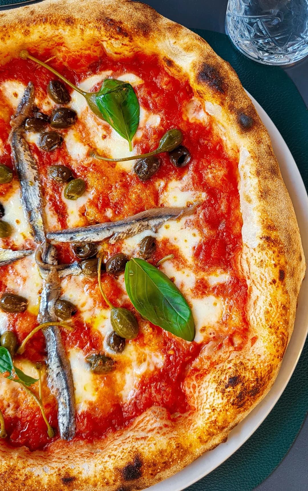 A Napoli pizza topped with anchovies and capers