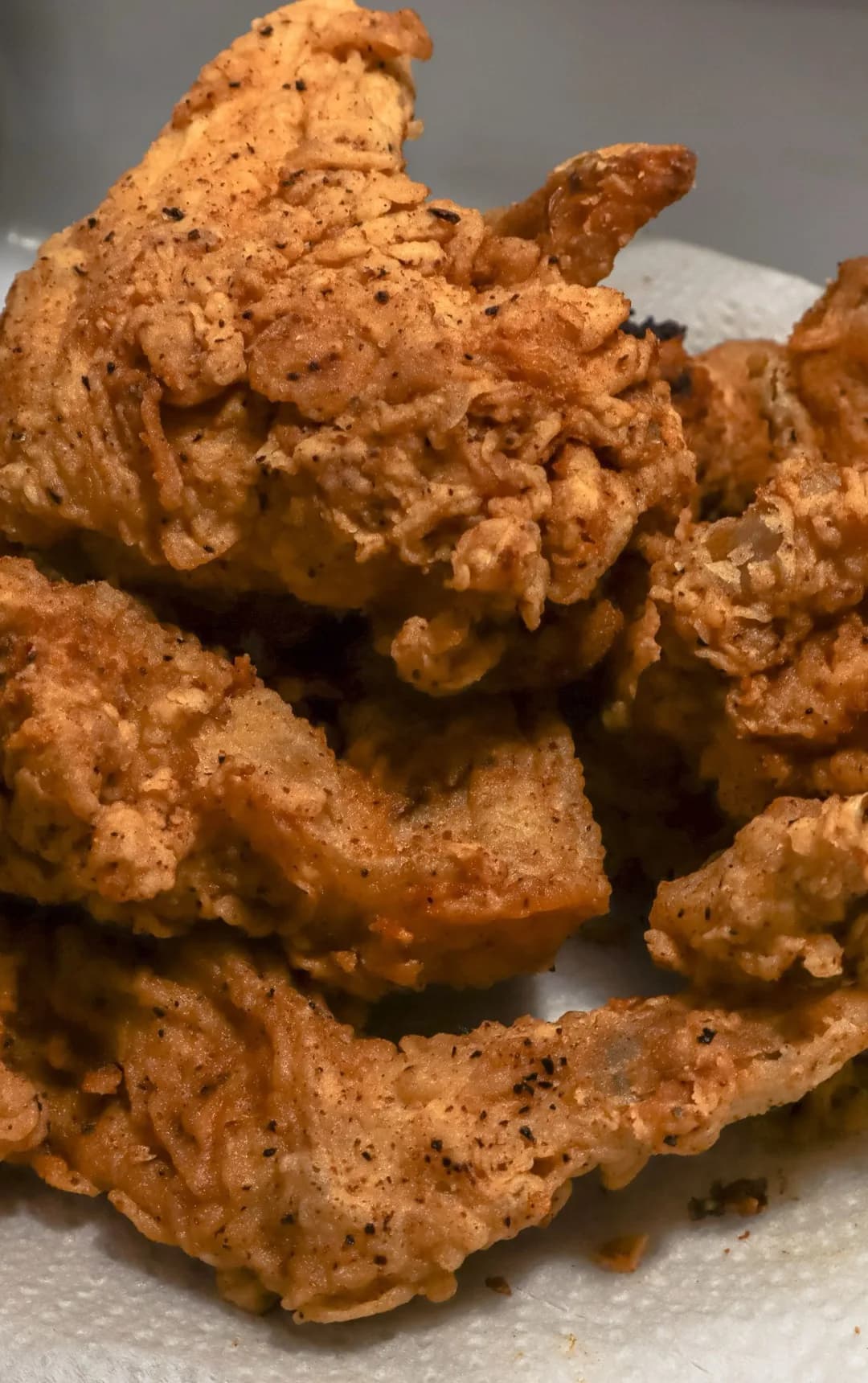 Crisp fried chicken pieces piled on a plate
