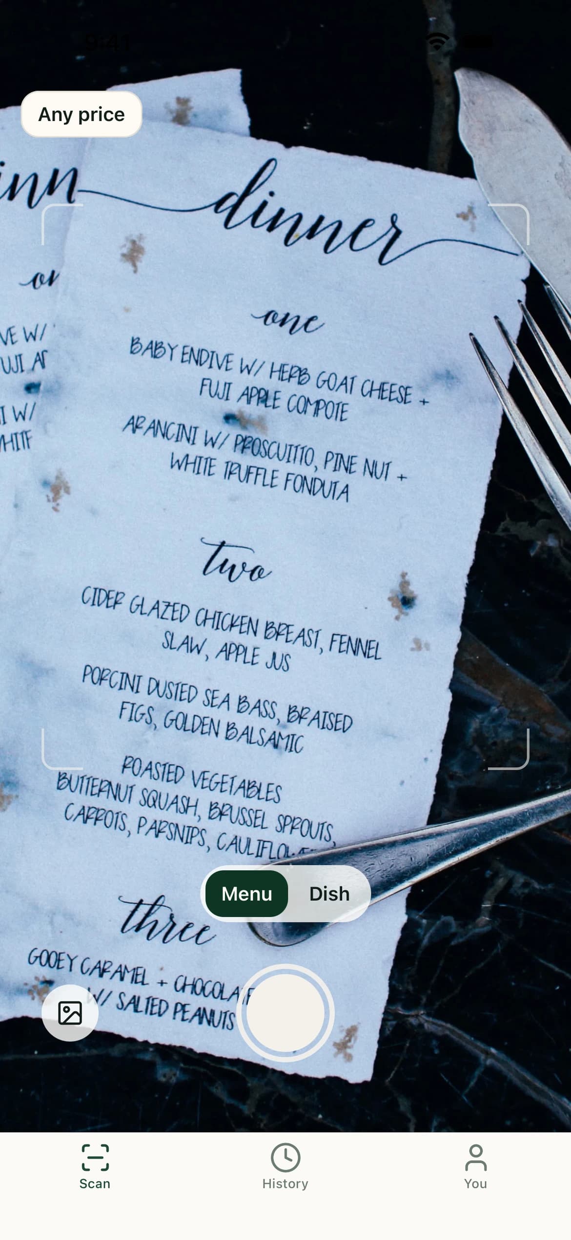 The camera framing a handwritten dinner menu on a restaurant table, ready to scan